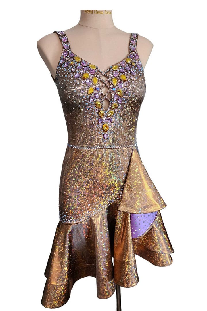 Golden Reverie Latin Dress in mannequin front view of gold dress with deep purple ruffle lining and heavy jeweled bodice