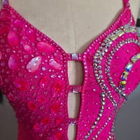 Close-up of Malibu Dream ballroom gown bodice with pink stones and shimmering rhinestones