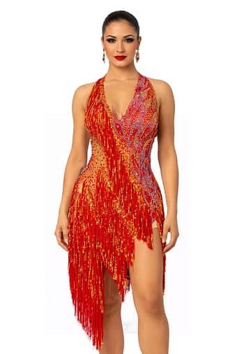 A woman wearing the Inferno Cascade Latin dance dress featuring red fringe, gold sequins, and intricate crystal embellishments.