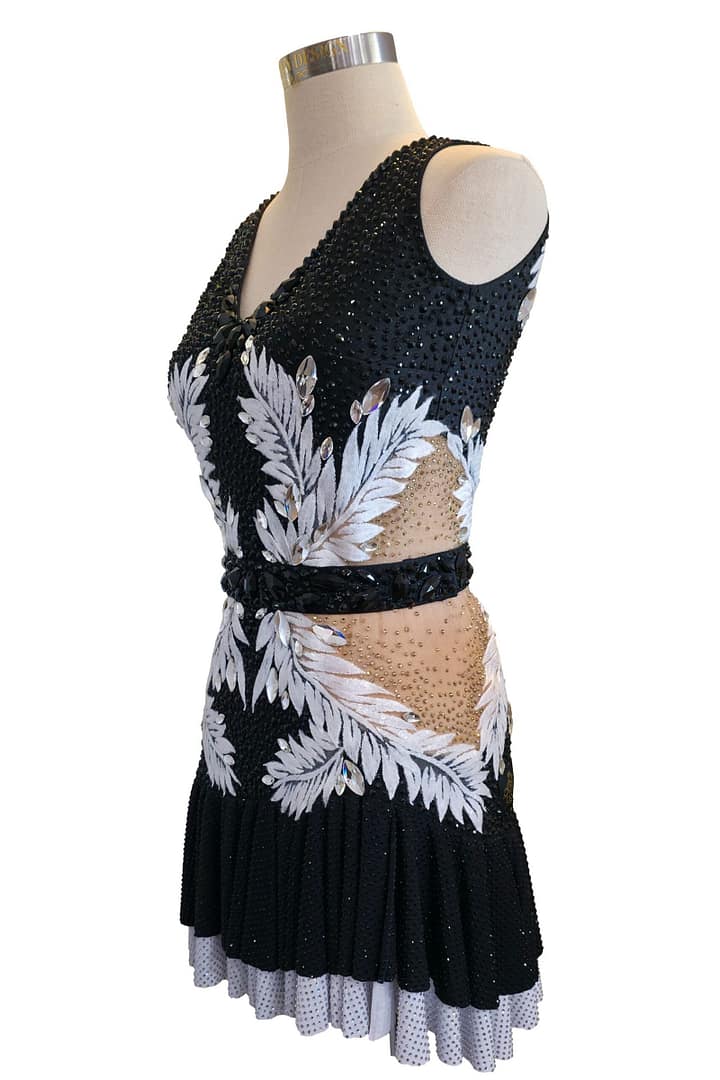Side view of Onyx Whisper Performance Series Latin dress with rhinestone detailing and layered Latin dance skirt