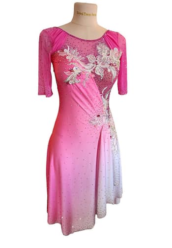 Radiant Beat Latin dress - front view - showcasing pink fabric with intricate silver floral appliqué and rhinestone embellishments.