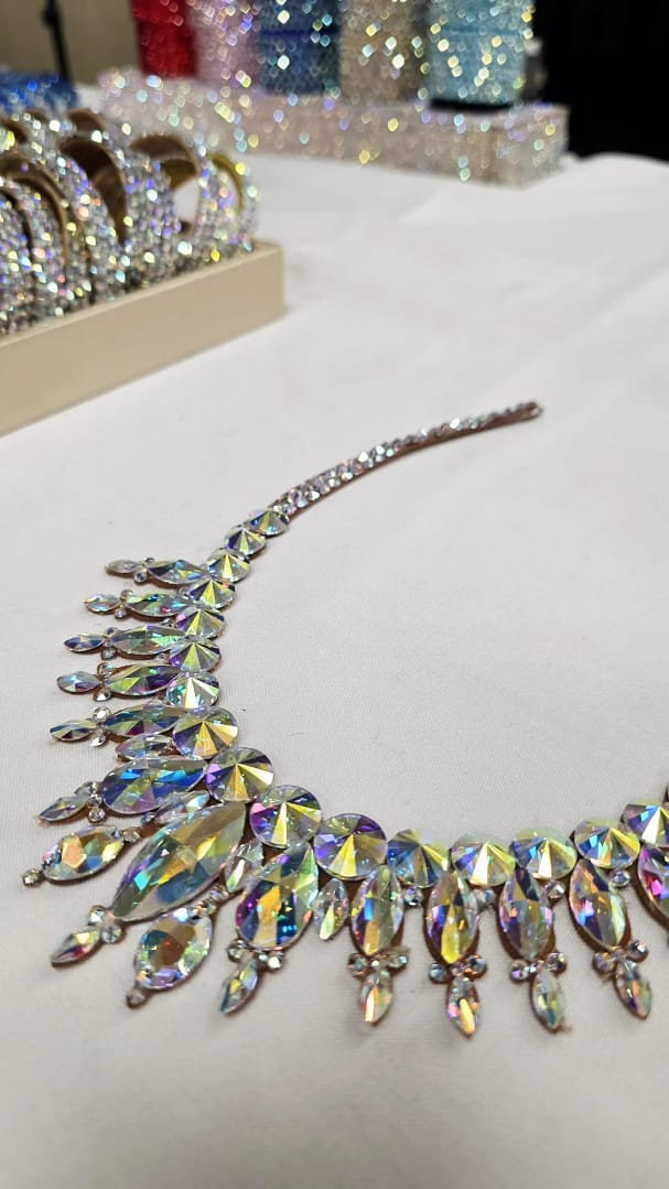 Angled view of a large crystal ballroom necklace with oversized AB stones designed for high-impact stage performance.