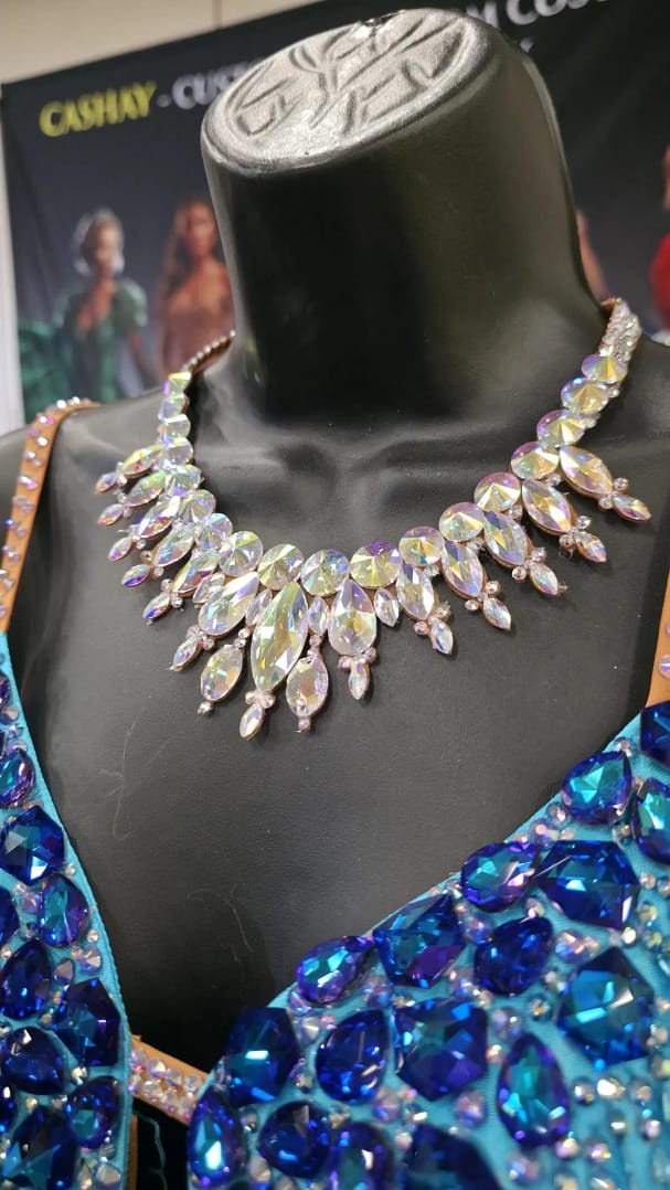 Large crystal ballroom necklace displayed on a mannequin, featuring oversized Crystal AB stones designed for strong stage sparkle and competition visibility.