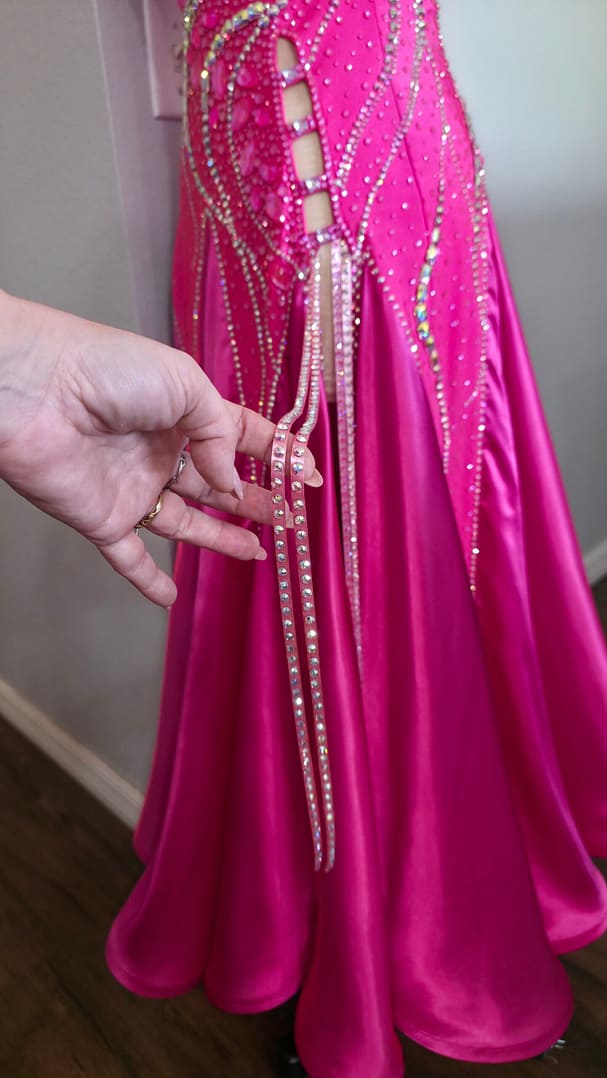 Detail of Malibu Dream ballroom gown straps and crystal accents on bright pink fabric