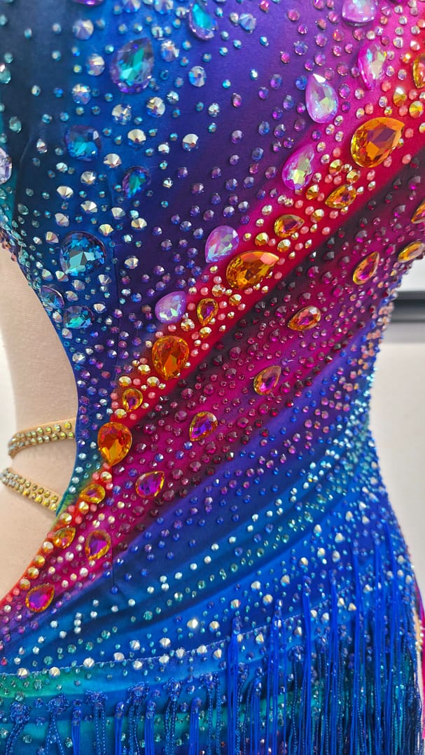 Chromatic Fire Latin dress bodice detail with multicolor gradient and large crystal stones