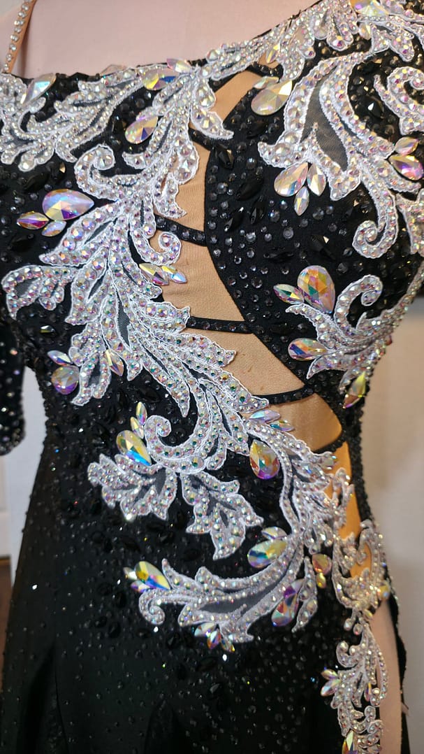 Close-up of the Crystal Nocturne Signature Series bodice featuring shimmering silver appliqué, premium rhinestones, iridescent crystal accents, and illusion cutout details.