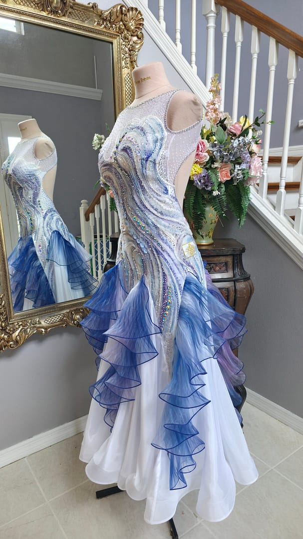 Crystal Current side view showing cascading sheer blue and lilac ruffles over a flowing white skirt