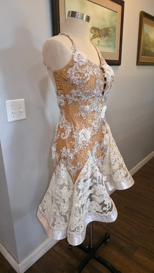 Lace Temptation dress shown from a three-quarter front view with crystal embellishments, lace appliqué, and a flared skirt