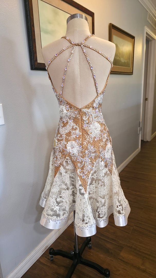 Lace Temptation dress shown from the back, featuring an open back with embellished rhinestone straps and a lace skirt
