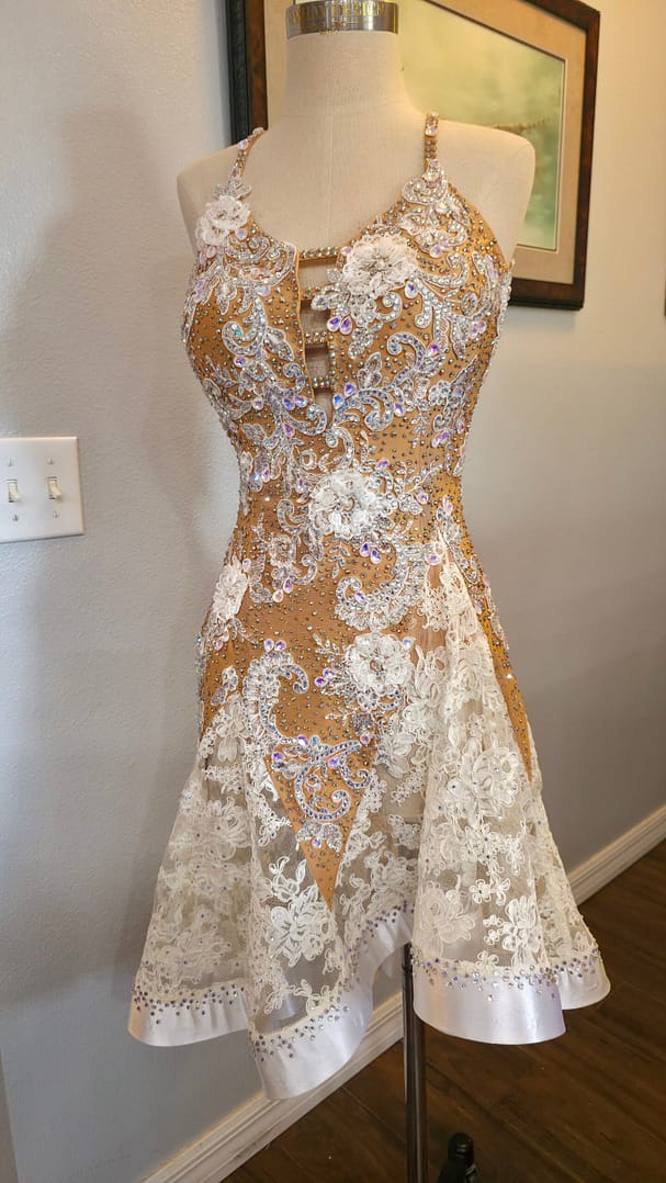 Lace Temptation dress shown from a three-quarter front view with crystal embellishments, lace appliqué, and a flared skirt