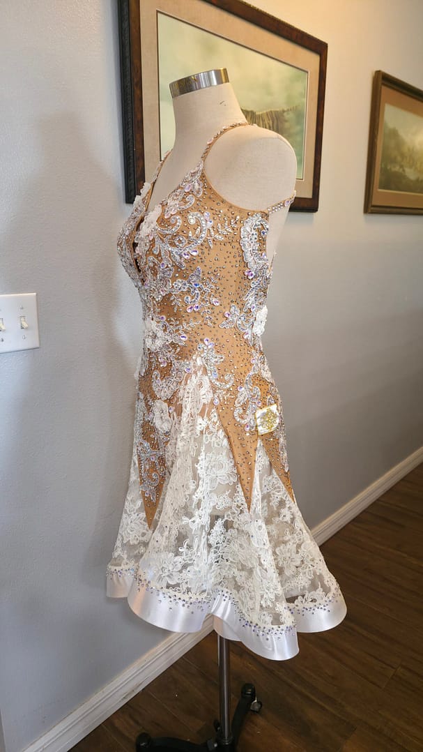 Lace Temptation dress shown from the side, featuring a fitted embellished bodice and flowing lace skirt