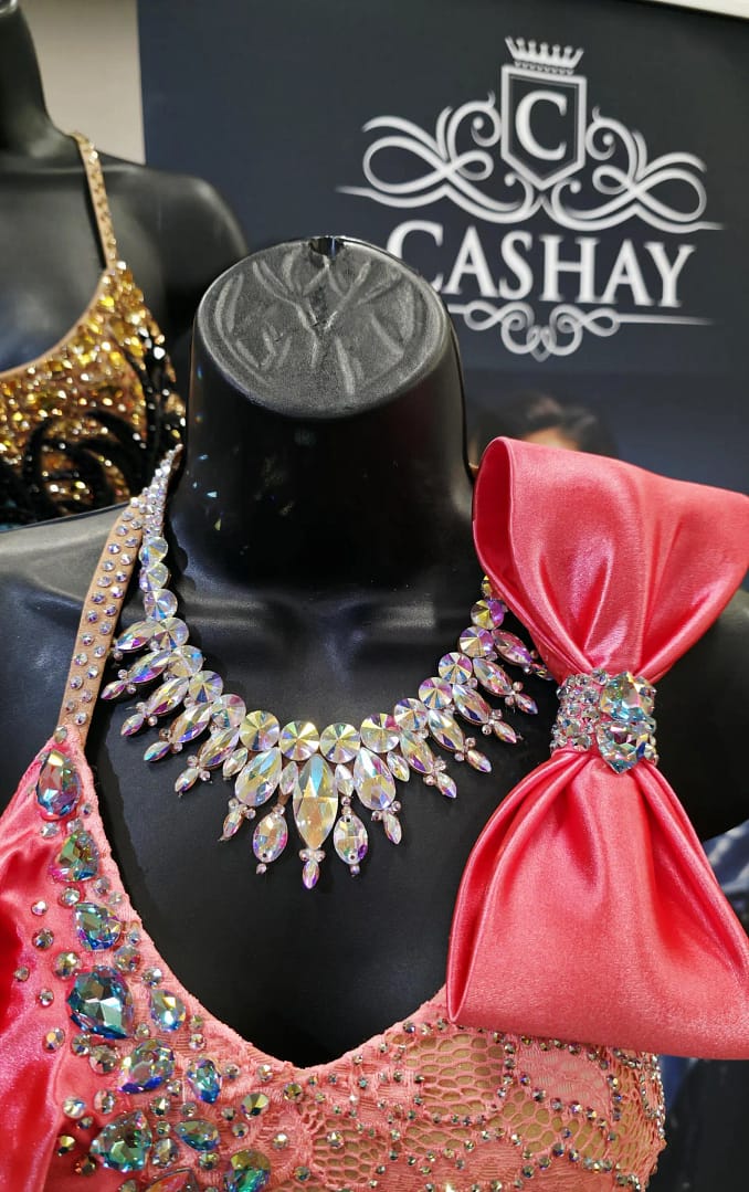 Large crystal ballroom necklace displayed on a mannequin, highlighting bold stone size and competition-ready design.