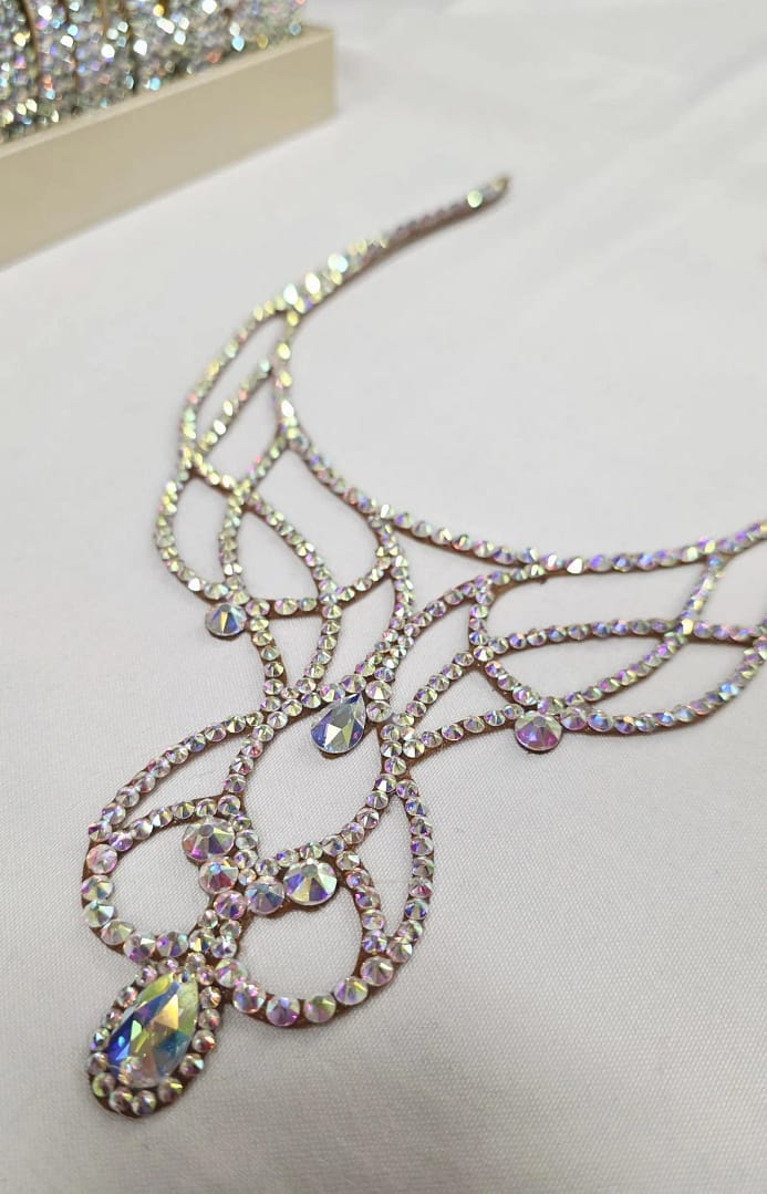 Close-up of crystal filigree ballroom necklace with AB stones and teardrop center detail