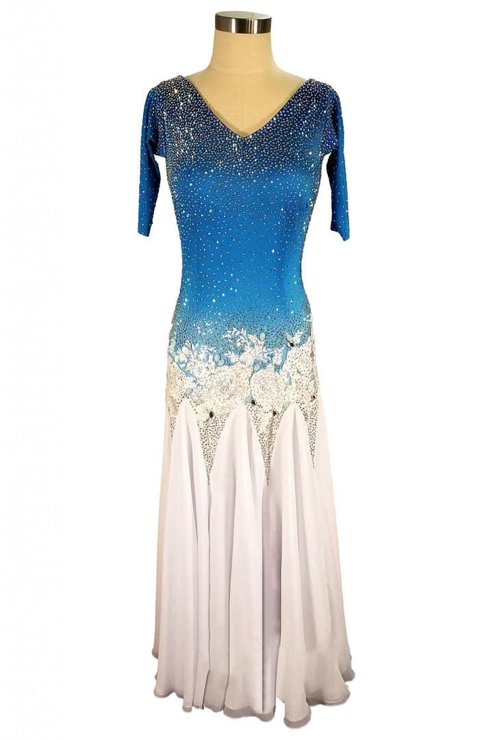 Blue fire ballroom gown — front view — Standard/Smooth gown featuring a vibrant blue bodice transitioning to white skirt, with a deeply stoned V-neckline and intricate white floral appliqué at the waistline.