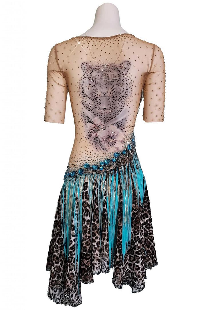 Midnight Ember Latin Dress back view mannequin displaying a striking tiger head tattoo appliqué on sheer nude mesh and asymmetric skirt