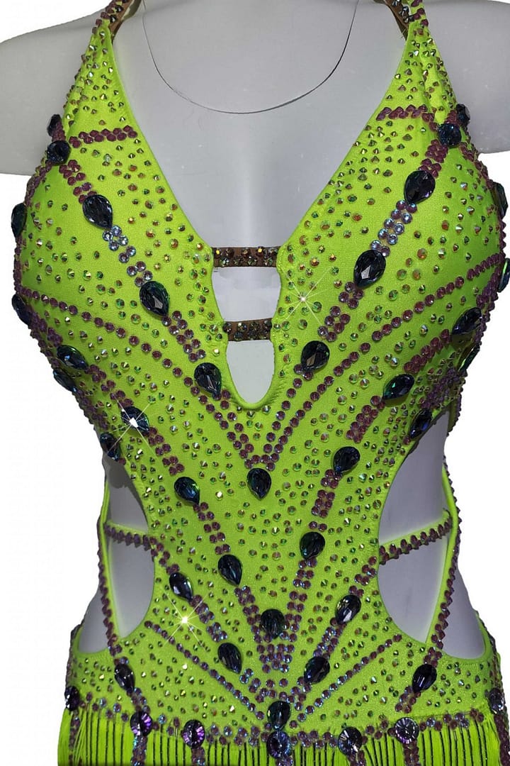 Sunshine Latin dress — bodice detail — close-up of neon yellow fabric with purple and black teardrop crystals