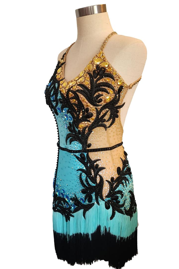 Aqua Noir Latin dress 3/4 view halter neckline with gold crystal stoning and nude mesh side panel.