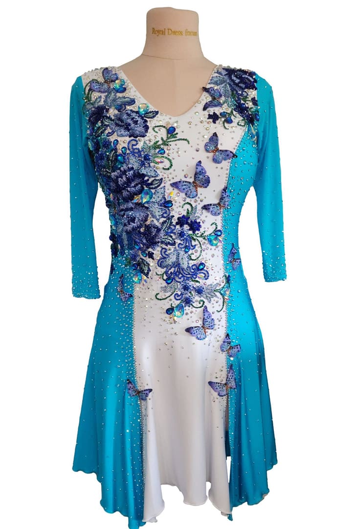 Azure Grace Latin dance dress front view with turquoise sleeves, white bodice, butterfly appliqués, and crystal detailing