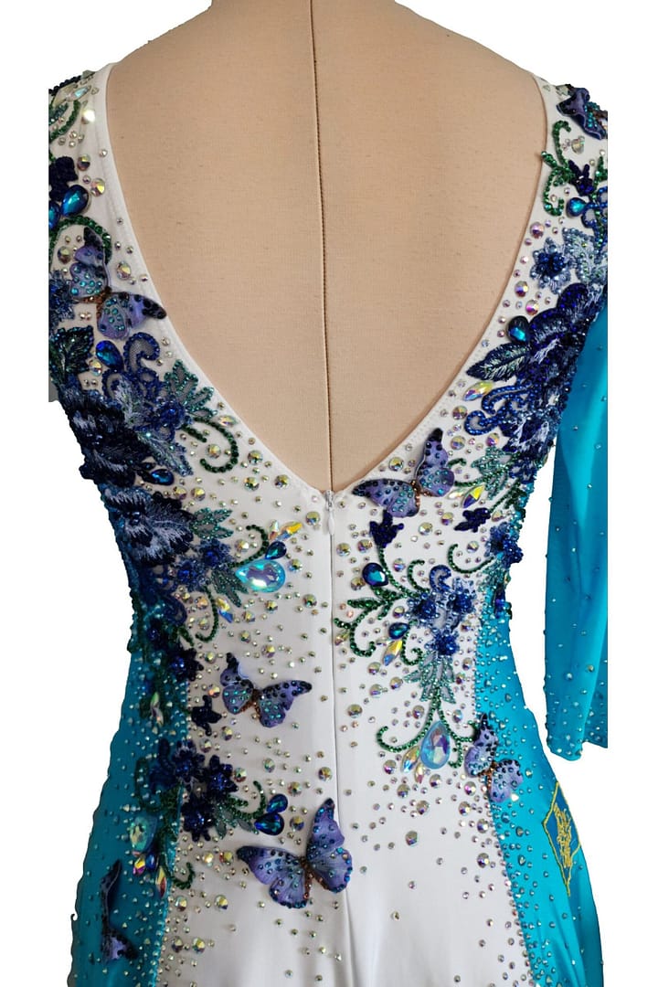 Close-up of Azure Grace Latin dress back neckline with embroidered blue florals, butterflies, and dense crystal embellishment