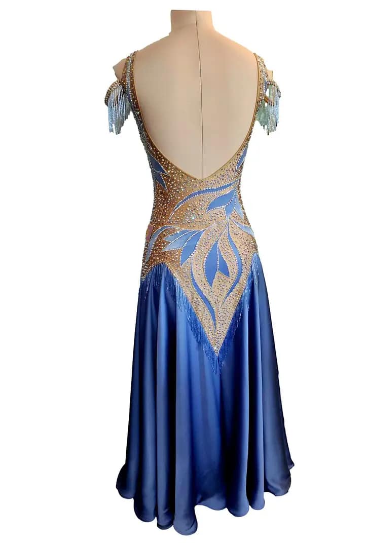 Back view of the Blue Silhouette Atelier ballroom gown featuring an open scoop back, crystal-trimmed neckline, and elegant sky blue ballroom skirt.