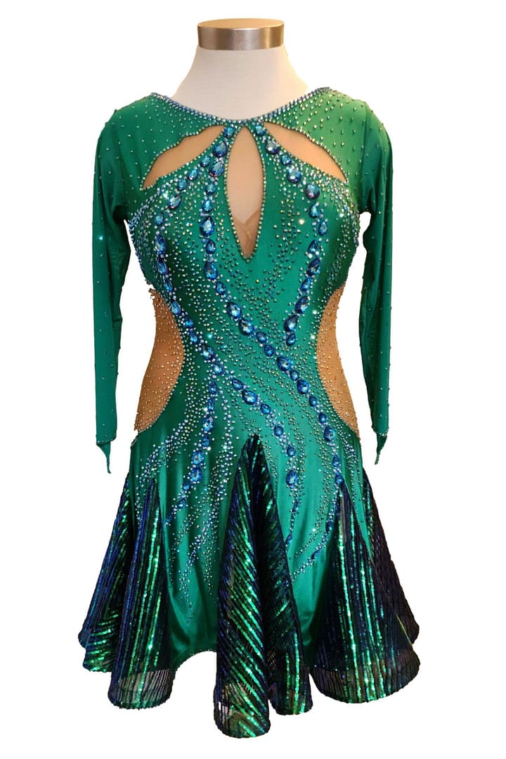 Front mannequin view of Emerald Majesty Latin dress featuring emerald stretch fabric, illusion cutouts, and blue crystal swirl stonework