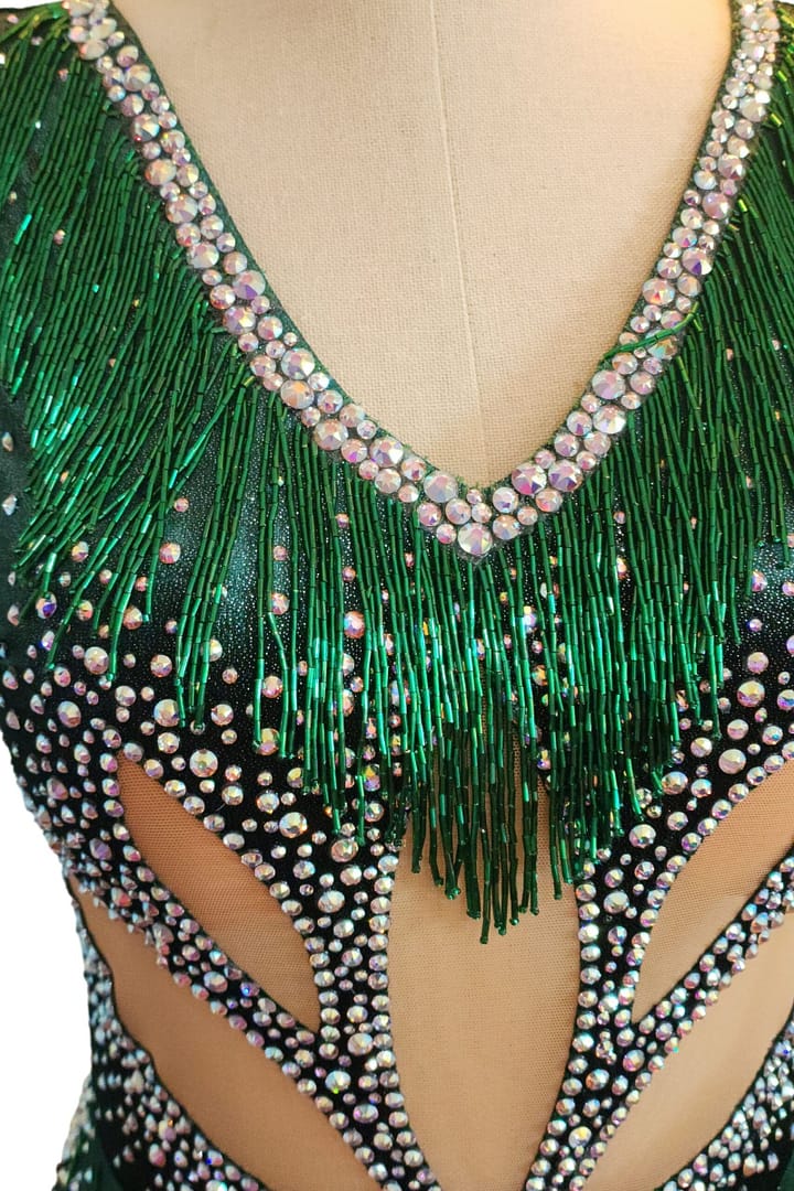 Close-up of emerald green Latin dress bodice with crystal fringe necklin