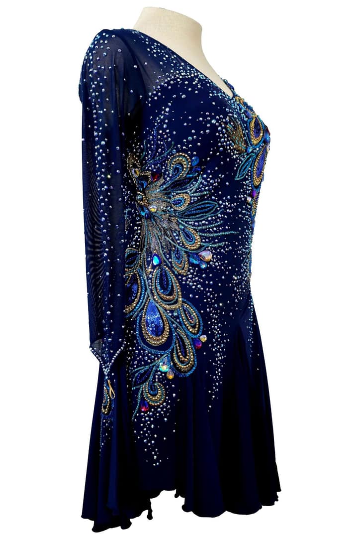 Side view of navy ballroom dress with feather-inspired crystal detailing and sheer sleeve