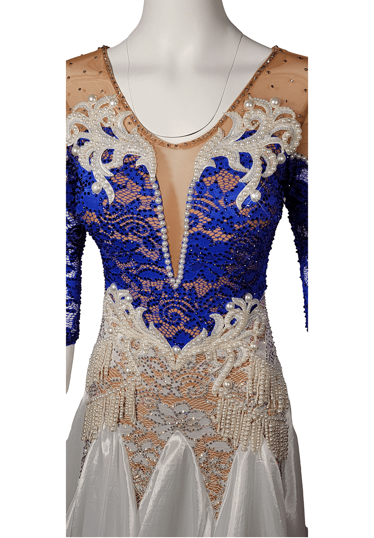 Galene ballroom gown — bodice detail — Close-up of the neckline showing a nude mesh yoke and deep V-plunge, decorated with white lace appliqué, strands of pearls, and a border of small rhinestones.