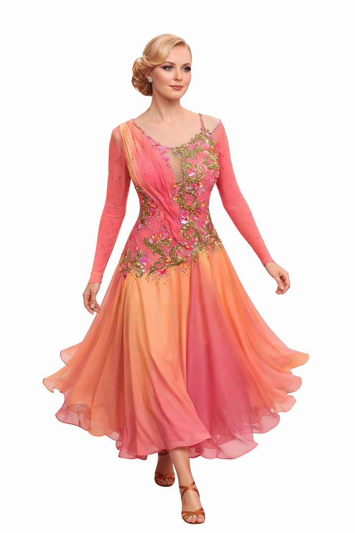Professional dancer in the Silken Radiance gown, showing movement in the coral ombre sunburst pleated skirt.