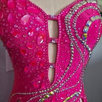 Front bodice view of Malibu Dream ballroom gown featuring pink crystals and cutout detail