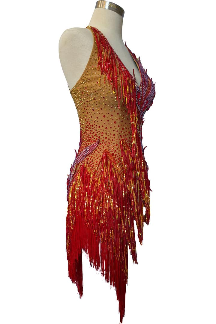 Side profile of the Inferno Cascade dress displaying the density of the red fringe and the detailed crystal patterns on the bodice.