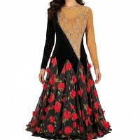 Fia ballroom gown — front view — A long-sleeved Standard dress with a two-tone bodice; the top-right quarter is tan mesh with crystals, and the bottom-left quarter is black velvet, separated by a diagonal line. The skirt is black sheer fabric printed with large, bright red roses.
