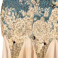 Blue fire ballroom gown — stonework close-up — Macro detail of the waistline where white lace and floral appliqué meets the blue bodice, accented with large, pear-shaped iridescent crystals and small seed beads.