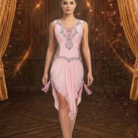 Blush Radiance Latin dress — front view — pleated peach fabric with lace-up plunge, crystal accents, and tassels