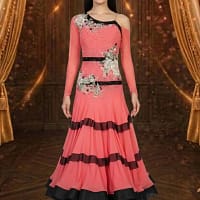 Coral Rhythm ballroom dance dress with black trim, floral embellishments, long sleeves, and layered flowing skirt