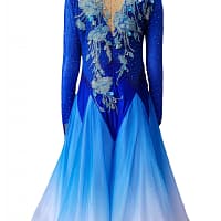 Zinnia ballroom gown — back view — deep blue gown with a nude mesh upper back and a dramatic full skirt in an ombré blue to white fade.