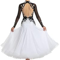 Lauren ballroom gown — back view — Long-sleeved black and white dress with a deep open-back design edged with black scrolling appliqué and clear crystals, over a nude mesh panel, leading to a white stoned skirt.