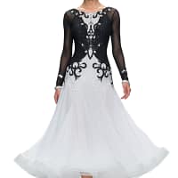 Lauren ballroom gown — front view — long sheer black sleeves, intricate crystal work on the bodice, and voluminous white skirt.
