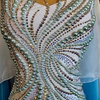 Cyra ballroom dress stonework. Aqua pearls and AB crystals in a swirl pattern detail.