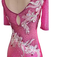 Gia Latin dress — 3/4 view — soft pink satin dress with asymmetric draping and silver embroidered florals creating graceful movement and shine.