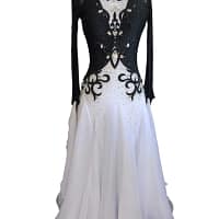 Lauren ballroom gown — front view in mannequin — The black and white Standard gown displayed on a mannequin, showcasing its long sheer black sleeves, intricate crystal work on the bodice, and voluminous white skirt.