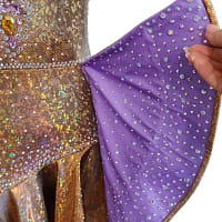 Lily Latin Dress — skirt detail — close-up of purple ruffle lining with AB crystals contrasting the gold outer layer