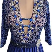 Pala Latin Dress — bodice detail — Close-up of the neckline showing the keyhole opening, the leopard print overlay, and a dense concentration of large, teardrop-shaped blue and iridescent accent crystals.
