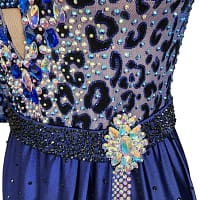 Pala Latin Dress — stonework close-up — Macro detail of the waist showing the black beaded belt, the large crystal brooch accent, and the sparkling blue-on-black leopard print stoning.