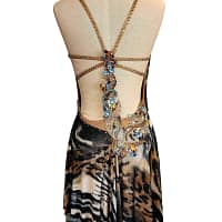 Kaya Latin dress — back view — backless Latin gown with a multi-strap design and a central cluster of large blue and gold stones over animal print fabric.