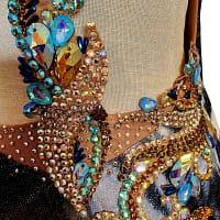 Kaya latin dress — stonework close-up — Extreme close-up of clustered gold and blue crystals in various shapes and sizes forming an ornate, swirling design.