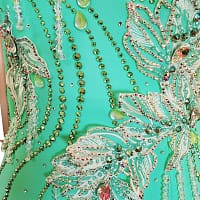 Calla ballroom dress — stonework close-up — lime green rhinestones and pear-shaped AB crystals on the bodice.