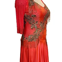 Crush Latin dress — side detail — close-up of the hip cutouts and the thick black bead fringe layered over orange mesh.