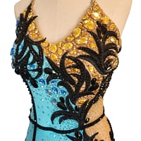 Jayla Latin dress — bodice detail — close-up of yellow teardrop crystals and black scrollwork appliqué on the gold half.