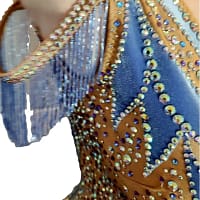 Close-up of the Blue Silhouette Atelier ballroom dress bodice showing nude illusion mesh, shimmering crystal stonework, and blue appliqué swirl accents.